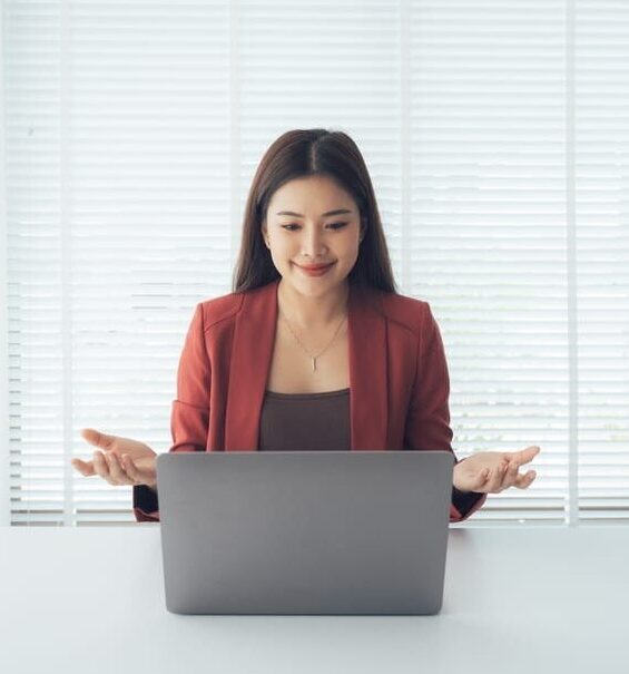 Woman working on laptop supporting assistant for e-filing management tasks