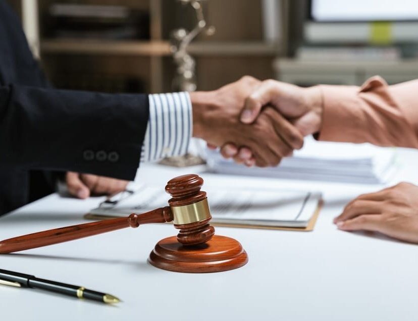 Close-up of hands of virtual legal assistants discussing and explaining legal matters with documents.